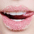 Pixelated close-up of lips with dark red lipstick and visible teeth, surrounded by four text on a peach background