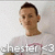 Pixelated image of a person with short dark hair wearing a light-colored shirt, with text below the head.