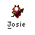 Pixelated character with red hair, white face, black horns, purple chest, and red checkered cape holding a red and black object against gray background.