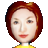 Pixelated portrait of a person with short reddish-brown hair, light skin, and a yellow top against a gray background.