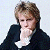 Two side-by-side pixelated portraits of a person with light brown hair, wearing dark jackets over white shirts against plain backgrounds.