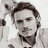 A pixelated grayscale image of a person with dark hair and a collared shirt appears on the left side of a bright yellow background, accompanied by blue text reading "He is So HOT!!!!!!!!!!!".