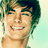 Pixelated image of a smiling person with brown hair on left, blue background with pixelated text on right.