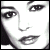 Pixelated grayscale portrait of a woman's face showing eyes, nose, and lips with high-contrast shading on white background.