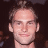 Static image shows a person with light brown hair against dark background, next to green text reading OriginalIcons.com in pixelated font.