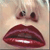 Pixelated close-up of a face with wide eyes and full red lips, showing a surprised expression against a light background.