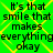 Green background with yellow diamond pattern and repeated black text 'It's that smile that makes everything okay' in pixelated font.