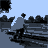 A 14-frame animated contact sheet showing a skateboarder performing tricks in a park setting with trees and open space, rendered in low-resolution pixel art style with blue sky background.