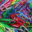Six display colorful paper clips in various arrangements against different backgrounds