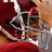 Pixelated static image of a character in a helmet with red accents and a metallic body against a red and brown background.