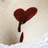 A red heart-shaped icon with a dripping effect on a light beige background, showing subtle animation changes across frames.