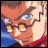 Pixelated anime-style character face with brown hair, blue eyes, and glasses, wearing red clothing against a blue background, with text reading 'AnimeIM' and 'COM' on black.