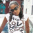 Pixelated image of a person with long dark hair wearing sunglasses and a white shirt, next to pink text on a light background.