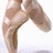 Pixelated image of a dancer's legs in motion with pink text labels on a light background.