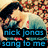 Pixelated image of a person with dark hair lying on patterned fabric, overlaid with blue text reading "nick jonas sang to me and 20,000 other people but forget them.".
