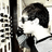 Static pixelated image of a person with dark hair and white clothing against a light background, partially obscured by vertical black bars.