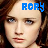 Pixelated static buddy icon featuring a person's face with blue pixelated text "RORY" overlaid at the top right, set against a dark brown background.