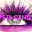 Animated close-up of a stylized eye with purple eyelashes and pink text reading 'SINGING' overlaid, showing a partial frame with a gray rectangle replacing the right eye section.