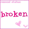 Static image with pink text 'current status:' above 'broken' and two pink hearts at bottom right on white background.