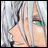 A pixelated anime-style character face with light blue hair and green eyes on the left, next to stylized text reading "Anime IM" above a smaller "com" on a black background.