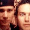 Two people in a close-up selfie with one wearing a dark cap, showing subtle facial expression changes across frames.
