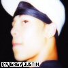 A pixelated close-up of a person wearing a white cap with dark trim, showing profile view against black background.
