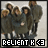 Group of people in dark coats standing together with text 'RELIENT K' and a heart symbol below, displayed