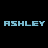 Static pixelated text icon displaying the name 'ASHLEY' in light blue block letters on a black background with slight visual artifacts.