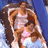 Pixelated image of a person with long brown hair wearing a white sleeveless top, standing against a blue background with light blue and white gradient elements.