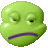 Pixelated green circular face with closed eyes, purple mouth, and white highlights on cheeks and forehead.