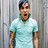 Pixelated static image of a person in light blue shirt against gray background with vertical lines.