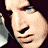 A pixelated image of a person with dark hair, showing two distinct facial expressions