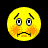 Pixelated yellow emoji face with raised eyebrows, wide eyes showing white pupils and black irises, orange blush marks on cheeks, a thin horizontal mouth line, and pixelated facial features against a solid black background.