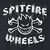 Pixelated static image with white text 'SPITFIRE' above a stylized skateboard graphic and 'WHEELS' below on dark background.