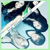 A static image shows a person with long dark hair wearing a green top and light blue shorts, holding a white pole with text, against a light background.