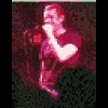 A person in a red shirt sings into a microphone across showing slight pose and expression changes
