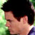 Static 50x50 pixel buddy icon showing a close-up profile of a person with dark hair against a green gradient background.