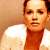 Pixelated image of a person in white and orange clothing against beige background, with green text reading Original Icons .com on dark green