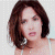 A pixelated image of a person with shoulder-length brown hair wearing a white top, next to green text on a dark background.