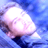 Pixelated static image of a light-colored rounded shape against blue background with visible dithering and compression artifacts.