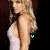 A woman in a white dress with long blonde hair stands against a dark background, her side profile visible.