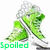 Green pixelated character with white hair and green clothing, standing in a dynamic pose above the word 'Spoiled' on a white background.