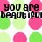Pixelated text on a polka-dot background with pink and green circles, stating 'you are beautiful no matter what they say words can't bring you down'.