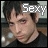 A pixelated image of a person with dark hair wearing a black shirt, featuring the word 'Sexy' in white block letters above their head.