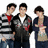 Three young men stand side-by-side against a white background, with green text reading "who doesn't love the Jonas Brothers" on the right.