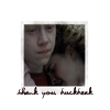 A static square image shows a person with light skin and dark hair wearing a light pink shirt over a dark red undershirt, with a blurred background and pixelated text below reading 'thank you feedback'.