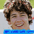 A person with curly brown hair smiling broadly, shown in a of four with one containing blue text