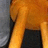 A static pixelated image shows a partial figure with orange and gray tones, featuring a dark vertical shape on the left and a dark rectangular block on the right.