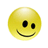 Yellow circular pixelated face with asymmetrical black eyes and a curved black smile on gray background