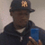A person wearing a dark hoodie and cap holds a blue phone, with text overlay changing from blank to 'sidekick 08' in the top-right